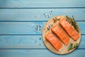 Fresh raw salmon and ingredients for marinade on light blue wooden table, flat lay. Space for text Royalty Free Stock Photo