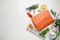 Fresh raw salmon and ingredients for marinade on white wooden table, flat lay. Space for text Royalty Free Stock Photo