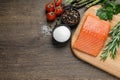 Fresh raw salmon and ingredients for marinade on wooden table, flat lay. Space for text Royalty Free Stock Photo