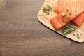 Fresh raw salmon and ingredients for marinade on wooden table, top view. Space for text Royalty Free Stock Photo