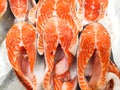 Fresh raw salmon steak slices for sale in the ice in market fridge. Red fish, showcase of fish store Royalty Free Stock Photo