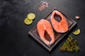 Fresh raw salmon steak with spices and herbs prepared for grilled baking Royalty Free Stock Photo