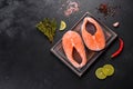 Fresh raw salmon steak with spices and herbs prepared for grilled baking Royalty Free Stock Photo