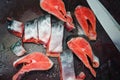 Fresh raw salmon steaks with salt on the rustic table Royalty Free Stock Photo