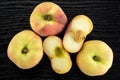 Fresh raw saturn peach on black wood Royalty Free Stock Photo