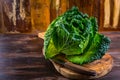 Fresh raw savoy cabbage on wooden background Royalty Free Stock Photo