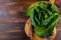 Fresh raw savoy cabbage on wooden background Royalty Free Stock Photo