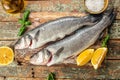 Fresh raw sea bass on a wooden background. banner, menu, recipe top view Royalty Free Stock Photo
