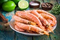 Fresh raw shrimps in a bowl with salt, pepper, lime