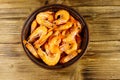 Fresh raw shrimps in a ceramic bowl on wooden table. Top view Royalty Free Stock Photo