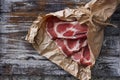 Fresh raw sliced meat on cooking paper and wooden table.