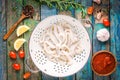 Fresh raw squid rings in a colander on a wooden table Royalty Free Stock Photo