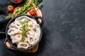 Fresh raw squid rings in a steel bowl. Black background. Top view. Copy space Royalty Free Stock Photo