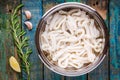 Fresh raw squid rings in a steel bowl on a wooden table Royalty Free Stock Photo