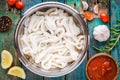 Fresh raw squid rings in a steel bowl on a wooden table Royalty Free Stock Photo