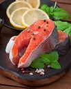 Fresh and raw steaks trout on a wooden cutting board