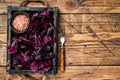 Fresh raw Swiss Ruby or red chard salad Leafs in a wooden tray. wooden background. Top view. Copy space