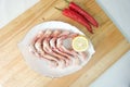 Fresh Raw Thigh Bone Chicken on a White plate and seasoning Royalty Free Stock Photo