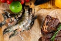 Fresh raw tiger prawns on the garden table. Surf and turf concept Royalty Free Stock Photo