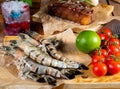 Fresh raw tiger prawns on the garden table. Surf and turf concept Royalty Free Stock Photo