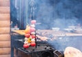 Fresh raw tomatoes onion mushroom eggplant on skewers over charcoal grid brazier grill