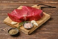 Fresh raw top side beef steak on wooden tabletop Royalty Free Stock Photo