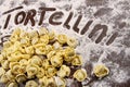 Fresh, raw tortellini with flour on table Royalty Free Stock Photo