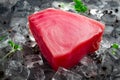 Fresh raw tuna fillet steak on ice a stone background with seasonings Royalty Free Stock Photo