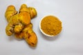 Fresh Raw Turmeric with Powder Close-Up on blurred White Background studio shot Royalty Free Stock Photo