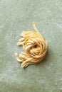 Fresh raw uncooked homemade twisted pasta tagliatelle