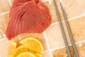 Fresh Raw Uncooked Yellow Fin Tuna Steaks With Lemon Slices