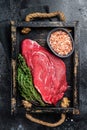 Fresh Raw veal meat with herbs and salt. Black background. Top view Royalty Free Stock Photo