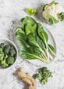 Fresh raw vegetables - chard, broccoli, cauliflower, peppers and ginger on a light background Royalty Free Stock Photo