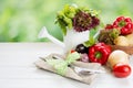 Fresh  raw vegetables in wooden plate  , fork and knife on white wooden table. Healthy eating and dieting concept Royalty Free Stock Photo