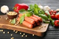 Fresh raw vegetarian sausages with basil, soybeans and vegetables on black wooden table Royalty Free Stock Photo