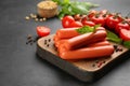 Fresh raw vegetarian sausages and vegetables on black table, closeup Royalty Free Stock Photo