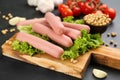 Fresh raw vegetarian sausages and vegetables on black table, closeup Royalty Free Stock Photo