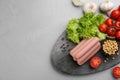Fresh raw vegetarian sausages and vegetables on grey table, flat lay. Space for text Royalty Free Stock Photo