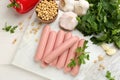 Fresh raw vegetarian sausages and vegetables on white wooden table, flat lay Royalty Free Stock Photo