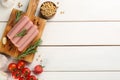 Fresh raw vegetarian sausages and vegetables on white wooden table, flat lay. Space for text Royalty Free Stock Photo