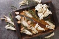 Fresh raw white and brown beech mushrooms with thyme and garlic on a kitchen cutting board. horizontal top view Royalty Free Stock Photo