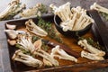 Fresh raw white and brown beech mushrooms with thyme and garlic on a kitchen cutting board. horizontal Royalty Free Stock Photo