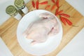 Fresh Raw whole chicken on a White plate and seasoning Royalty Free Stock Photo