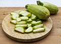 Fresh raw zucchini slices on wooden table. Royalty Free Stock Photo