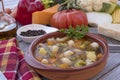 A fresh, ready-to-eat homemade vegetable soup. Raw vegetables on the wooden table, black pepper, olive oil and parmesan Royalty Free Stock Photo