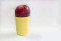 Fresh red apple on cup yellow. Royalty Free Stock Photo