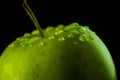 Fresh red apple with droplets of water against black background reflection drops Royalty Free Stock Photo