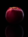 Fresh red apple with droplets of water against black background reflection drops fresh splash action movement Royalty Free Stock Photo