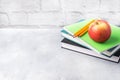 A fresh red apple on a stack of books and notebooks. The concept of a school breakfast snack. Copy space Royalty Free Stock Photo