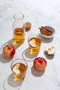 Fresh red apples and apple juice in glasses and bottle on a light background. Fruits and drinks. Top view, copy space.